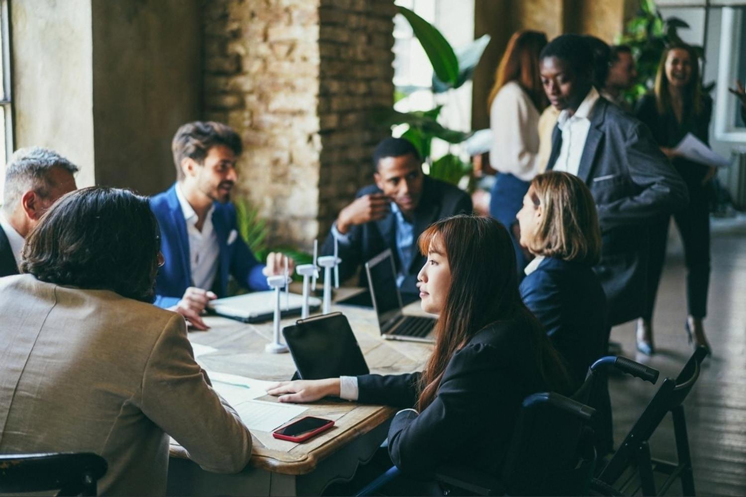 Diverse team of young professionals in a modern UAE office meeting