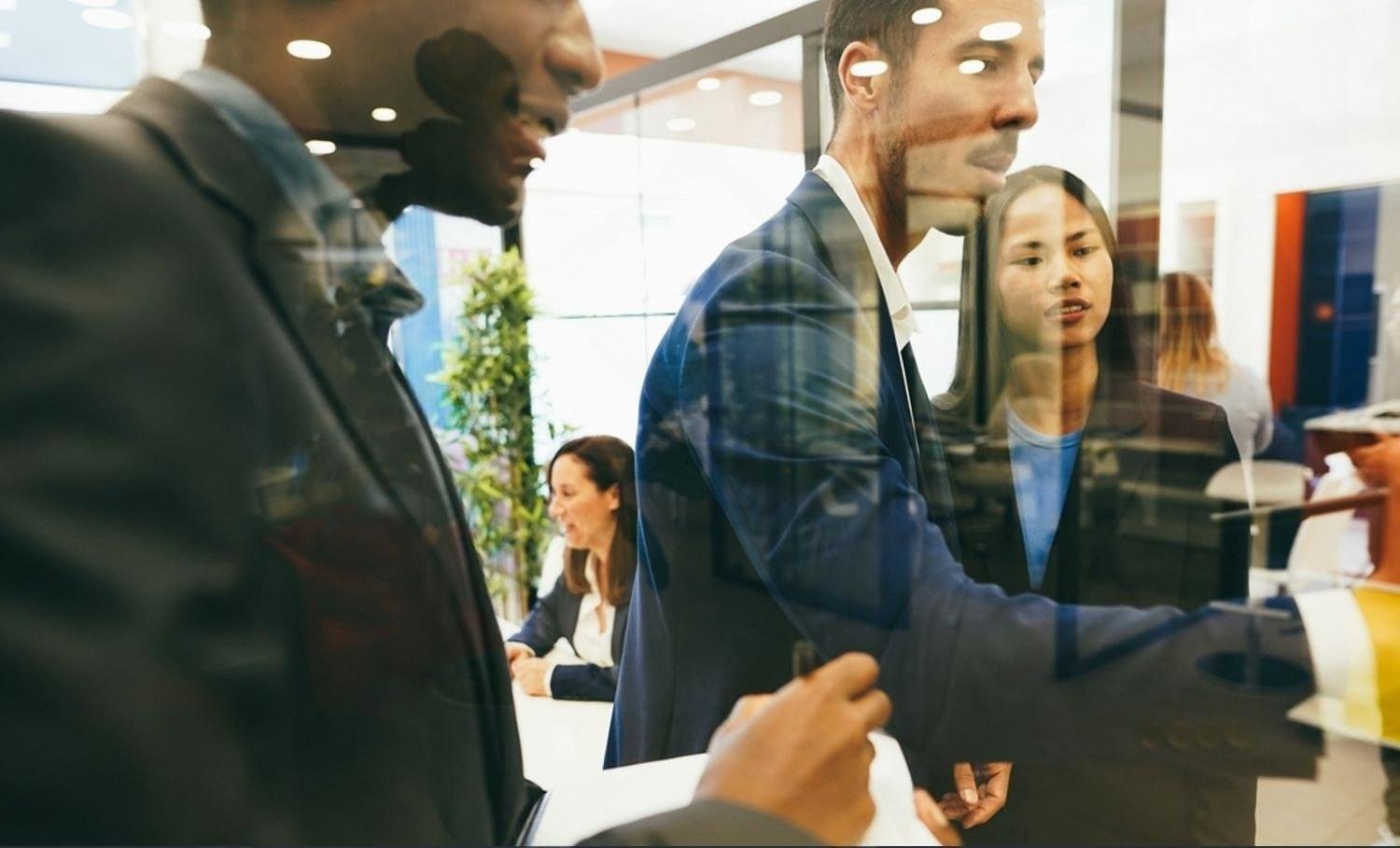 Young professionals presenting during a workplace discussion in Abu Dhabi